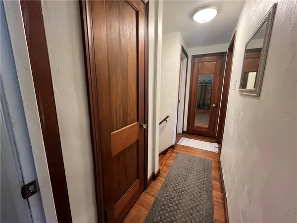 a view of an entryway with wooden floor