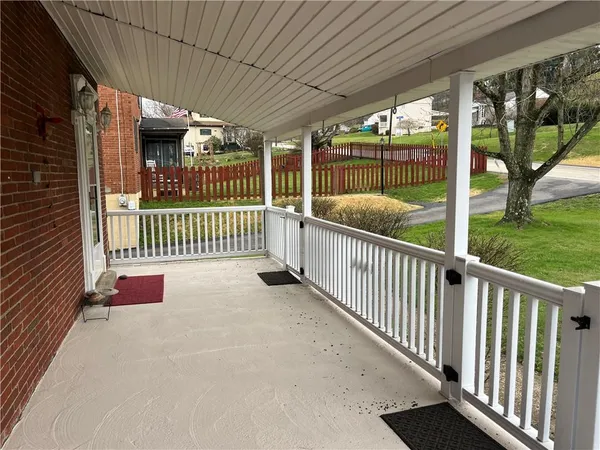a view of balcony with wooden floor and outdoor seating