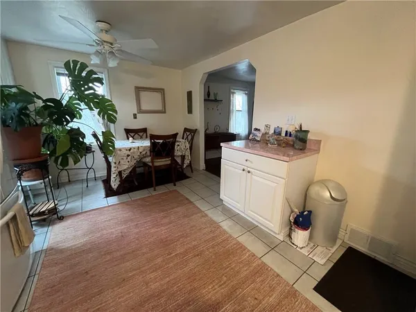 a kitchen with a refrigerator a stove top oven and white cabinets