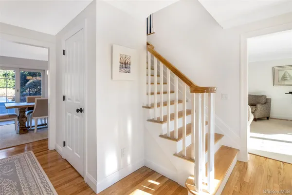 a view of a hallway with wooden floor and entryway