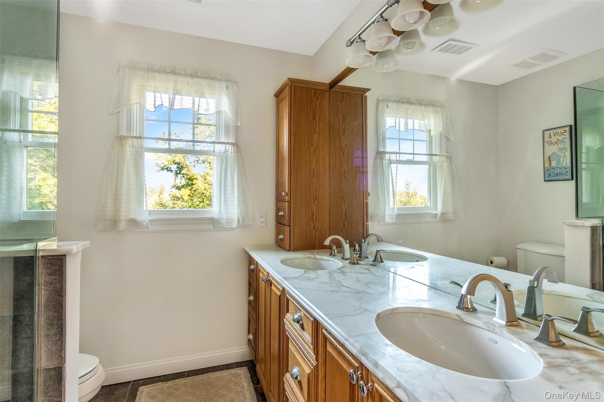 435 Luptons Point Road Mattituck, NY 11952 - Photo 21 of 27 a bathroom with 2 sink and a mirror