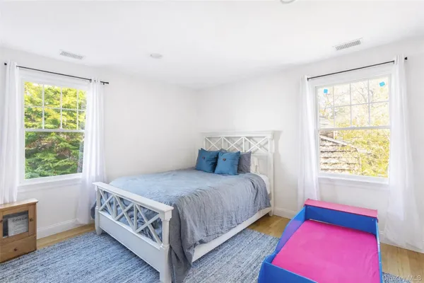 a bedroom with furniture and a window
