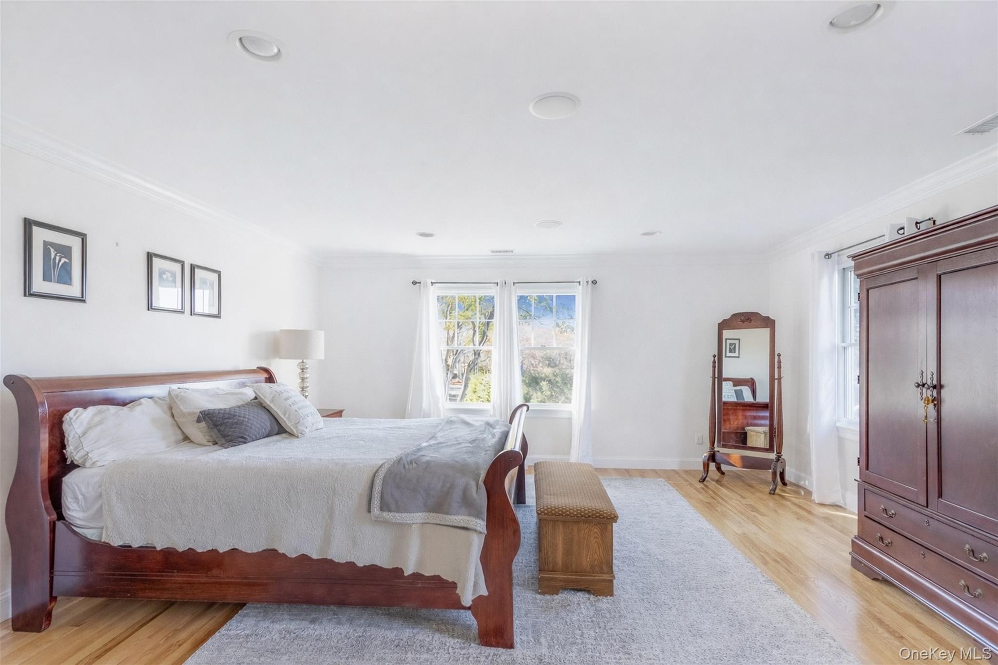 435 Luptons Point Road Mattituck, NY 11952 - Photo 25 of 27 a bedroom with a bed and a dresser
