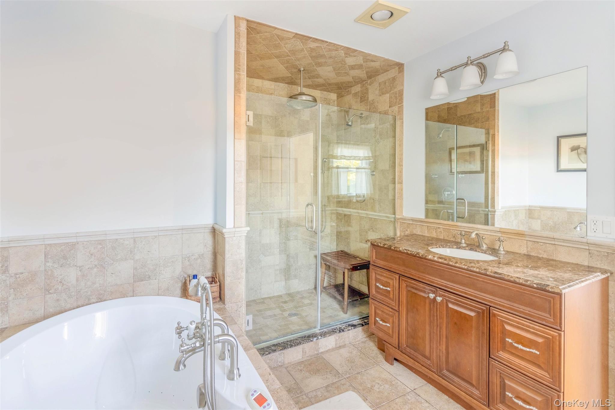 435 Luptons Point Road Mattituck, NY 11952 - Photo 26 of 27 a spacious bathroom with a granite countertop tub sink and mirror