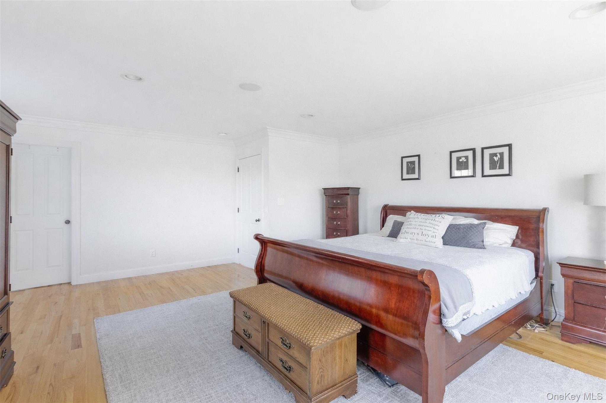 435 Luptons Point Road Mattituck, NY 11952 - Photo 27 of 27 a bedroom with a bed and a night stand
