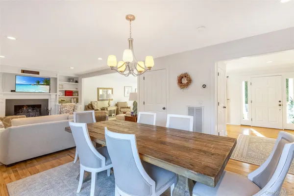 a view of a dining room with furniture wooden floor and chandelier