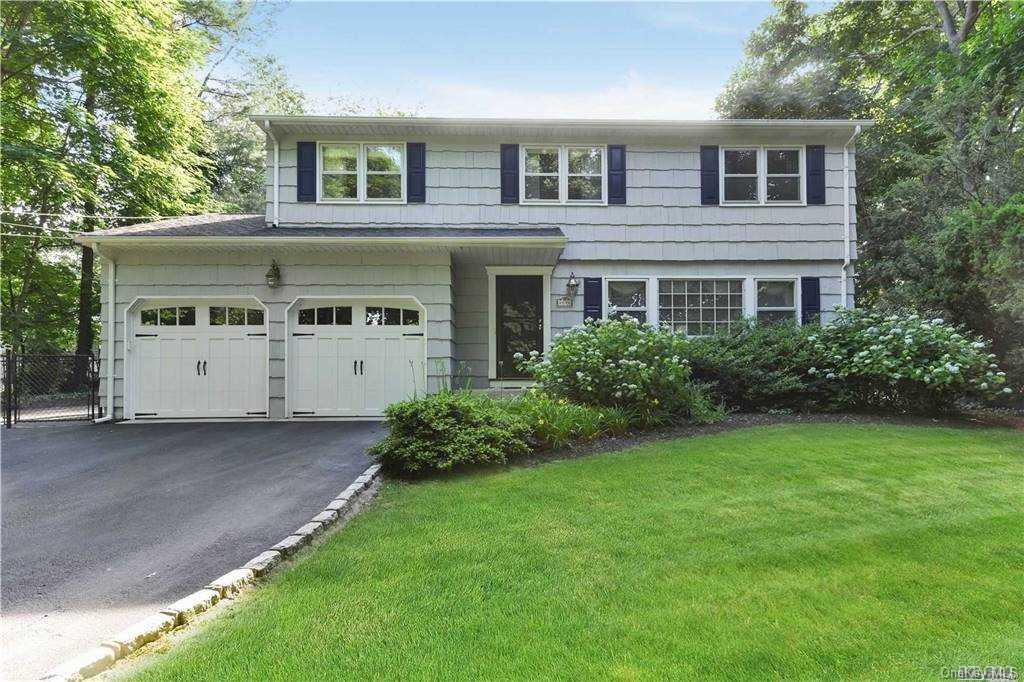 89 Little Neck Road Centerport, NY 11721 - Photo 1 of 1 a front view of a house with a yard and garage