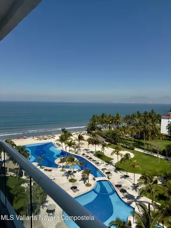a view of a dining table and chairs in the balcony