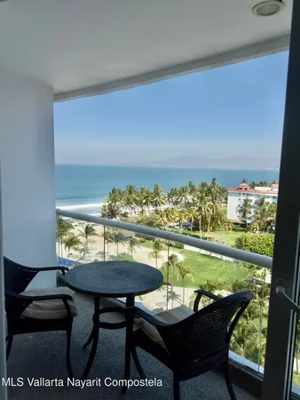 a balcony with furniture and outside view