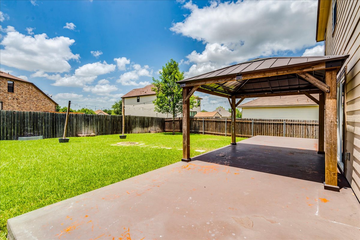 401 Waterleaf Boulevard Kyle, TX 78640 - Photo 4 of 28 Patio the width of the home with pergola