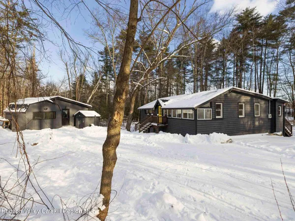 a front view of a house with snow yard