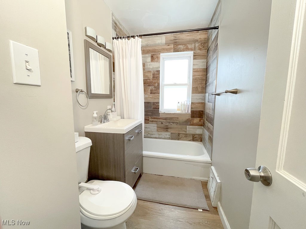 2707 Hearthstone Road Cleveland, OH 44134 - Photo 34 of 49 Full bathroom with toilet, vanity, wood finished floors, shower / tub combo, and visible vents