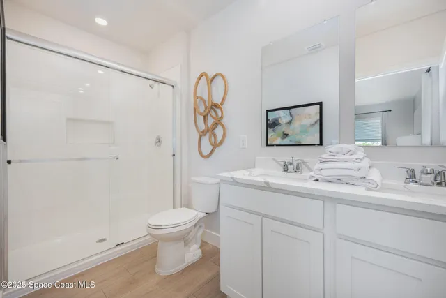 a bathroom with a toilet a sink and a mirror