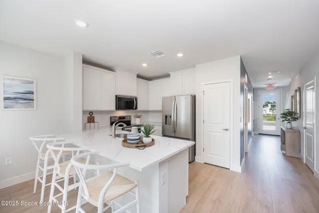 a kitchen with stainless steel appliances a refrigerator and a sink
