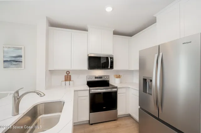 a kitchen with a refrigerator stove and sink