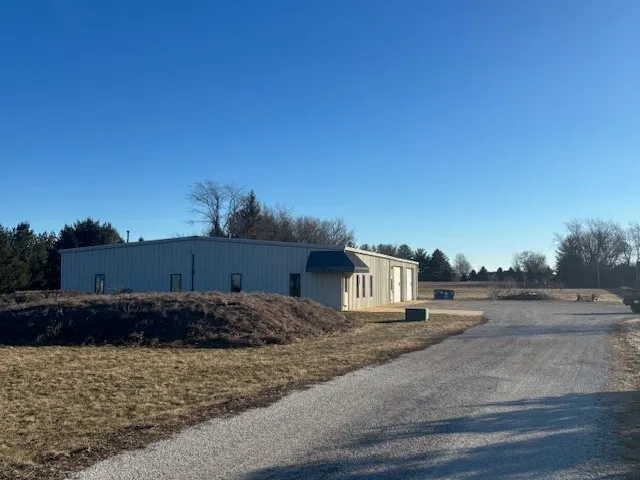 a view of a dry yard with wooden fence
