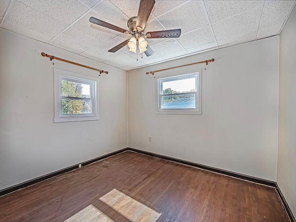 1694 Dime Road Vandergrift, PA 15690 - Photo 12 of 35 an empty room with wooden floor ceiling fan and windows