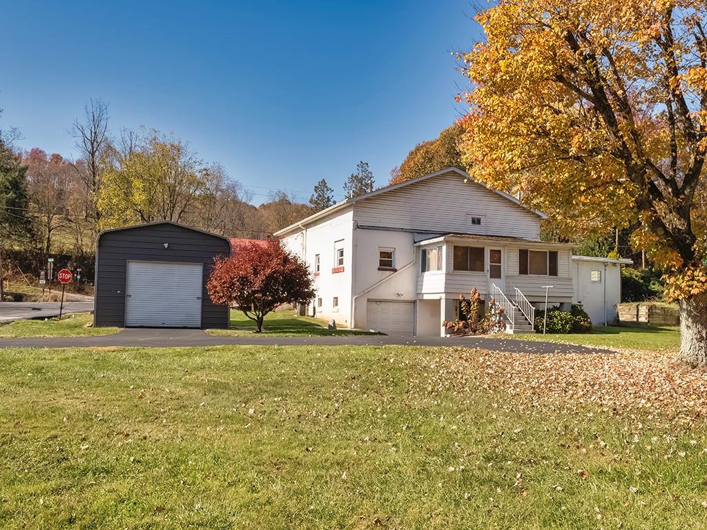 1694 Dime Road Vandergrift, PA 15690 - Photo 2 of 35 a front view of a house with a yard and garage