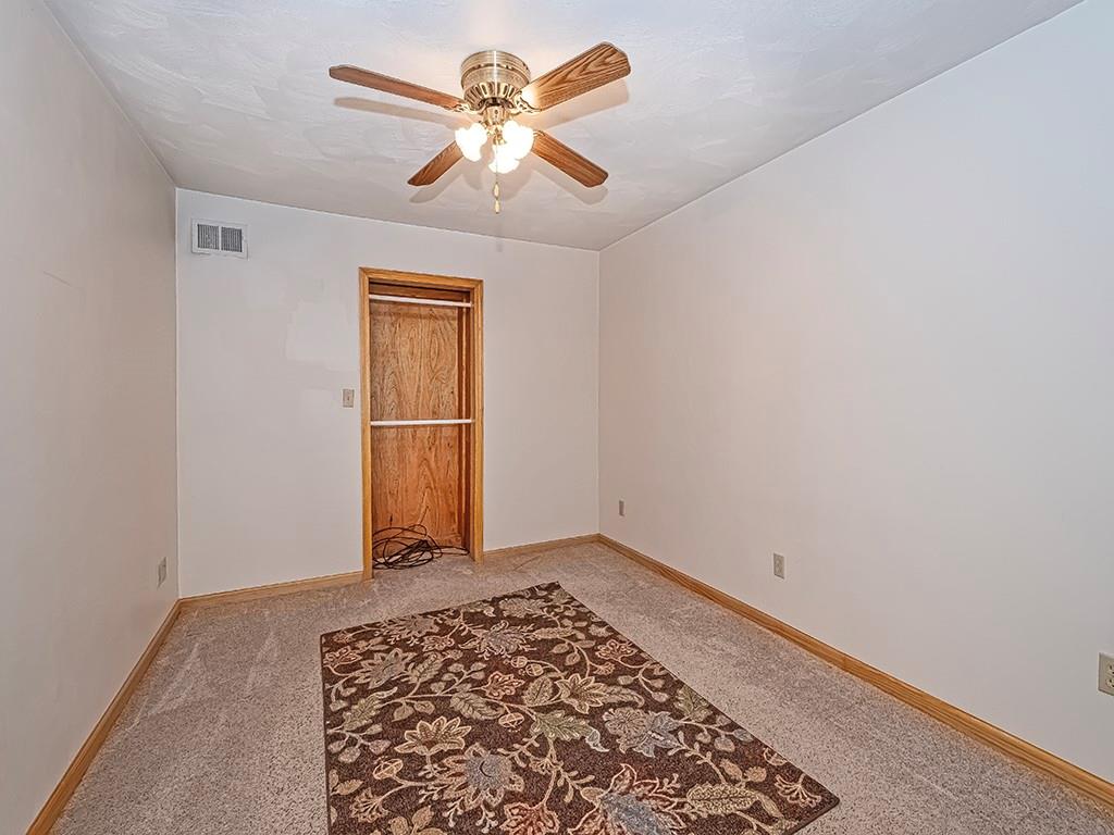 1694 Dime Road Vandergrift, PA 15690 - Photo 33 of 35 an empty room with wooden floor a ceiling fan and a window