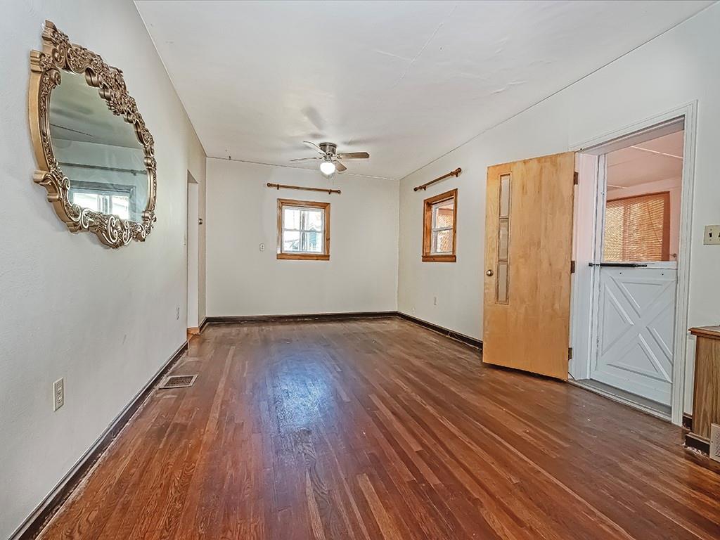 1694 Dime Road Vandergrift, PA 15690 - Photo 4 of 35 an empty room with wooden floor cabinet and windows
