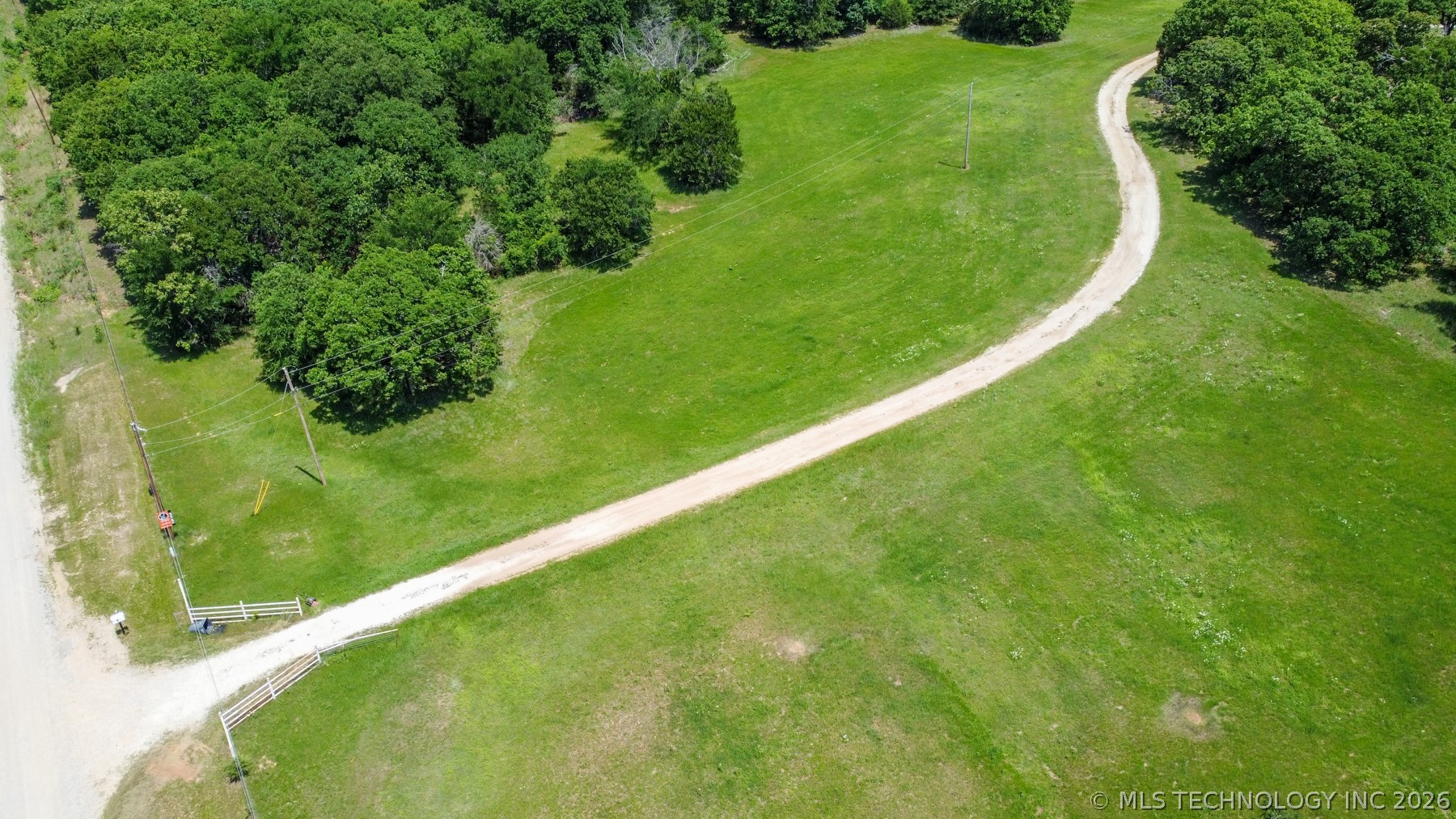 13248 North 3540th Road Maud, OK 74854 - Photo 23 of 98 Gravel drive winding through expansive green acreage