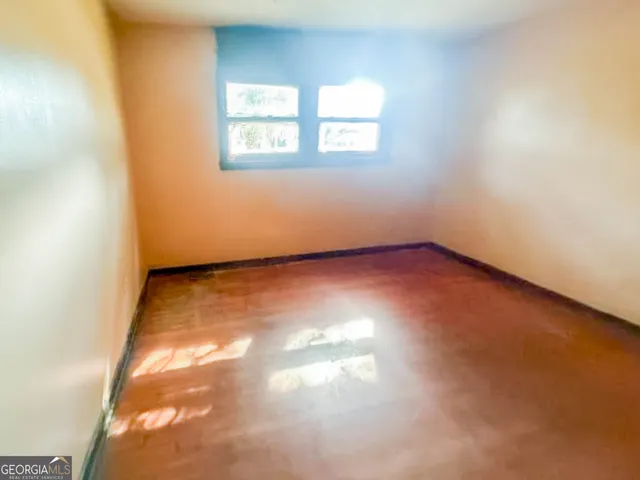 an empty room with an entrance to other room
