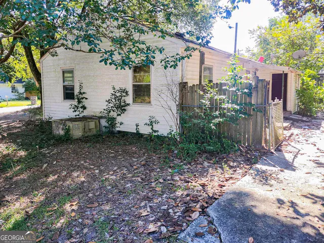 a backyard of a house with plants and trees