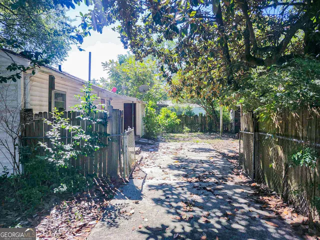 a view of a house with a yard and tree