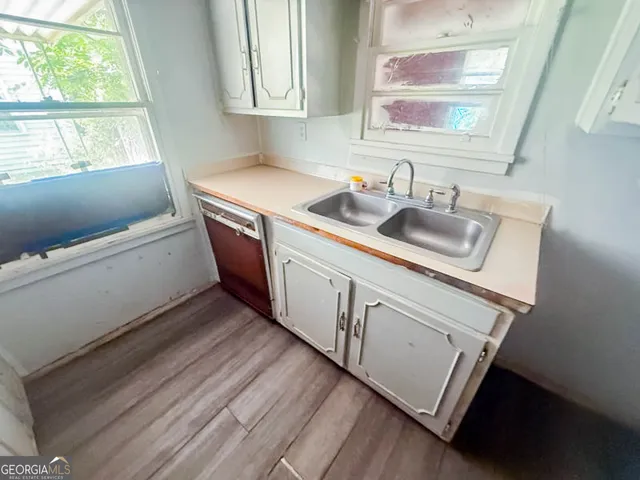 a kitchen with a sink stove and cabinets