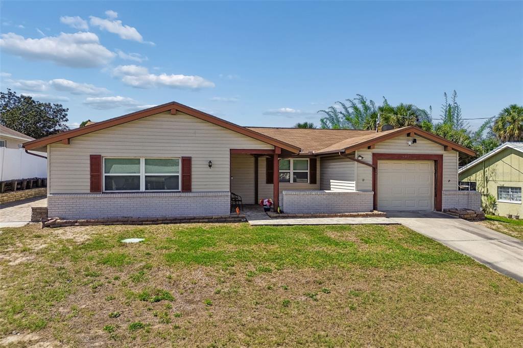 a front view of a house with a garden and yard