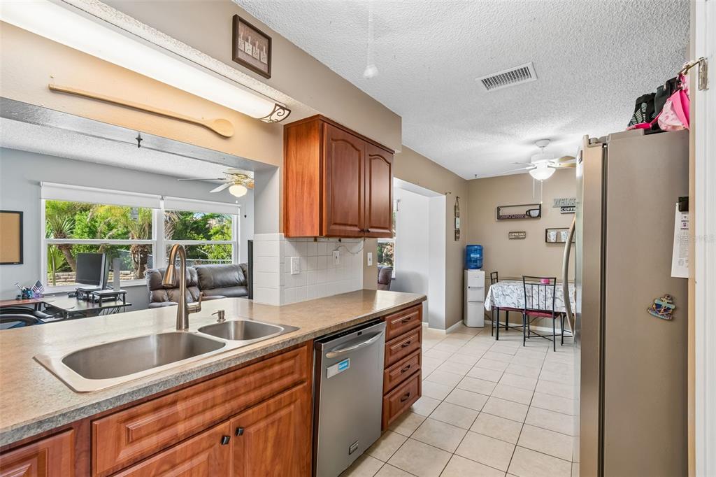 5478 Waycross Drive Spring Hill, FL 34606 - Photo 13 of 29 a kitchen with a sink window and cabinets