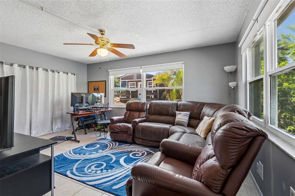5478 Waycross Drive Spring Hill, FL 34606 - Photo 17 of 29 a living room with furniture a fireplace and a window