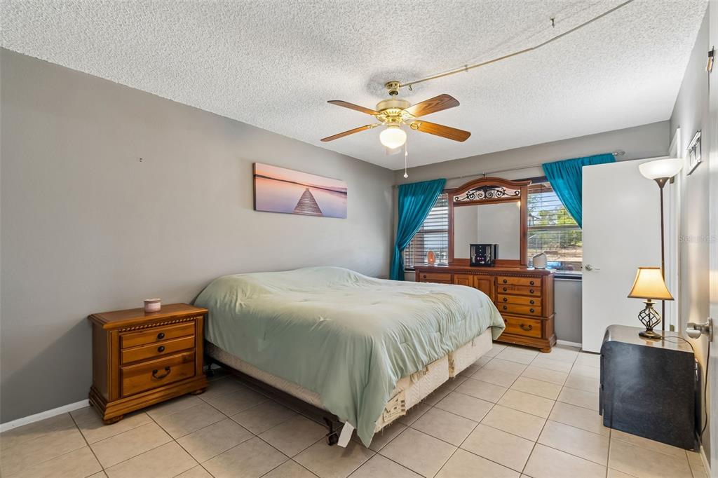 5478 Waycross Drive Spring Hill, FL 34606 - Photo 19 of 29 a bedroom with a bed and a chandelier