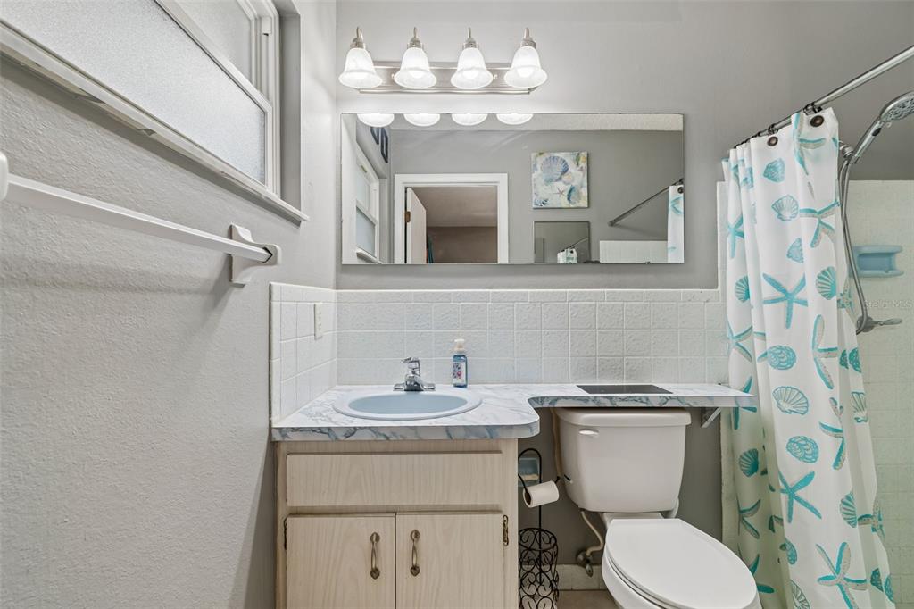 5478 Waycross Drive Spring Hill, FL 34606 - Photo 20 of 29 a bathroom with a sink vanity mirror and toilet