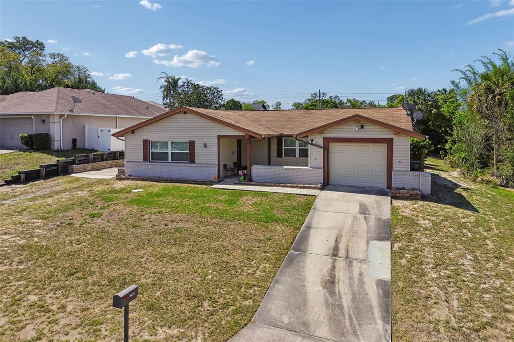 5478 Waycross Drive Spring Hill, FL 34606 - Photo 28 of 29 a front view of a house with a yard and potted plants