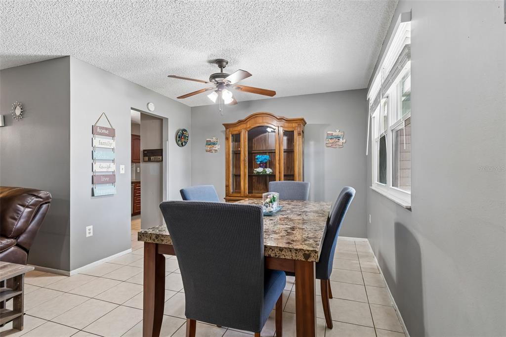 5478 Waycross Drive Spring Hill, FL 34606 - Photo 10 of 29 a view of a dining room with furniture and a chandelier