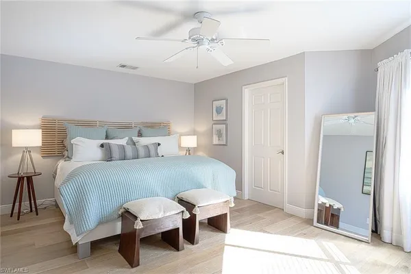 a bedroom with a bed and a lamp