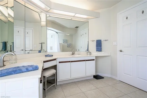 a bedroom with two beds and a potted plant