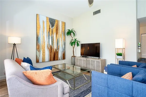 a living room with furniture and a flat screen tv