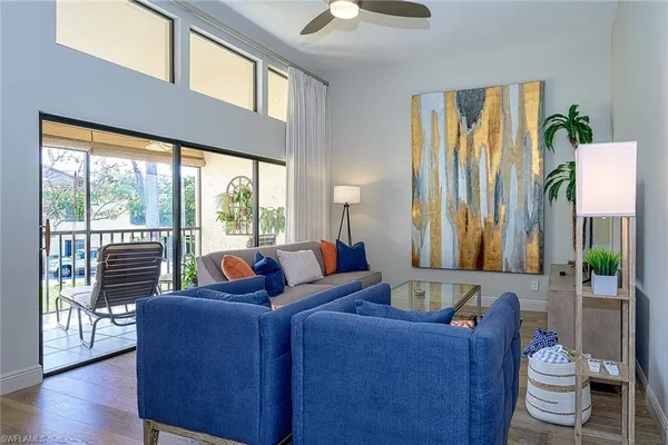 a living room with furniture and a floor to ceiling window