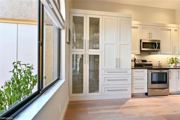 a kitchen with appliances and cabinets