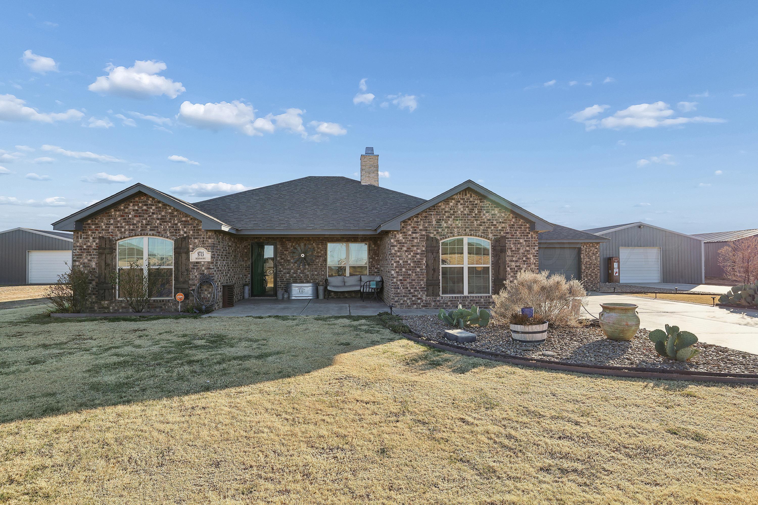 9715 Mossberg Street Canyon, TX 79015 - Photo 1 of 32 a front view of a house with a yard