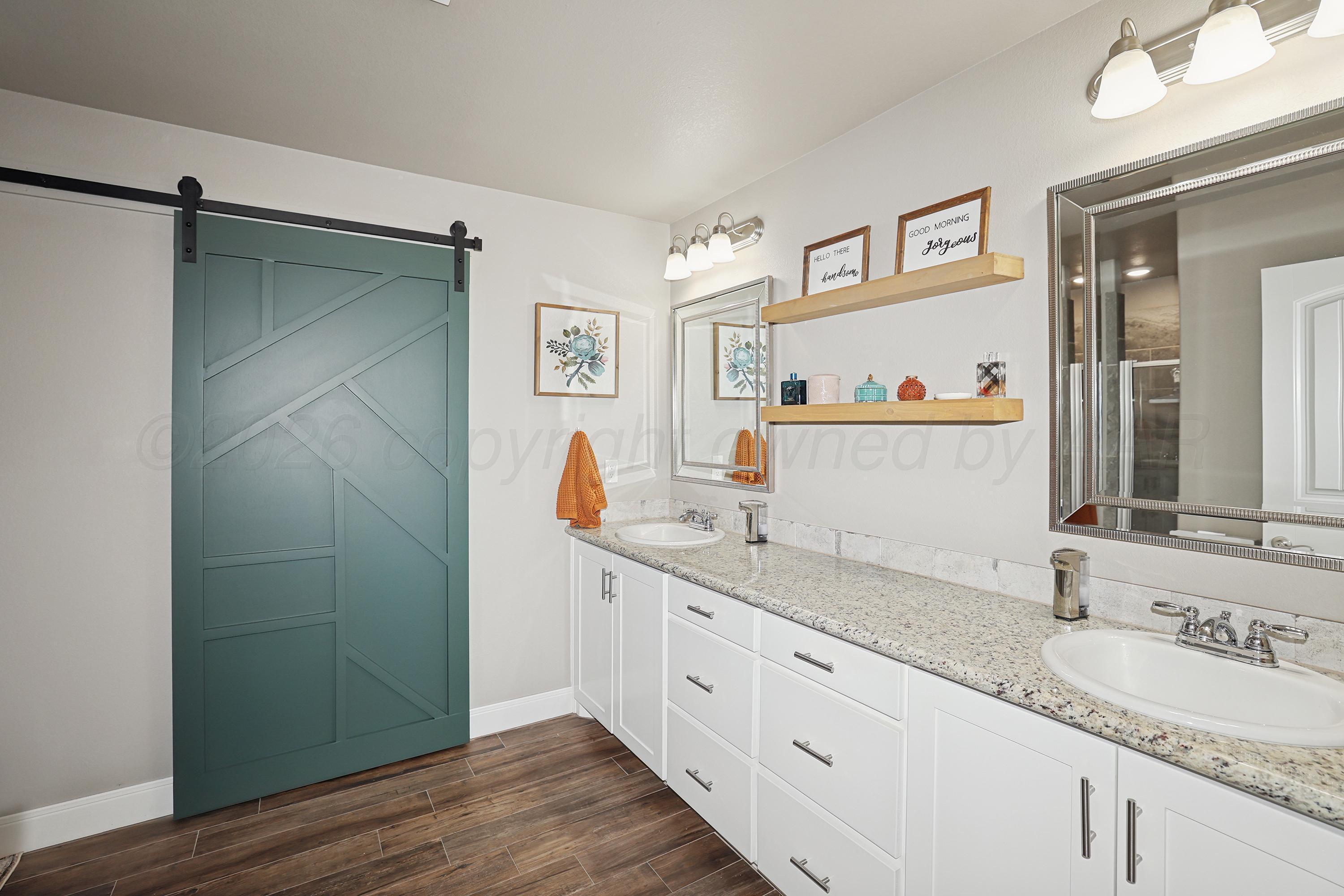 9715 Mossberg Street Canyon, TX 79015 - Photo 15 of 32 a bathroom with a granite countertop sink and a mirror
