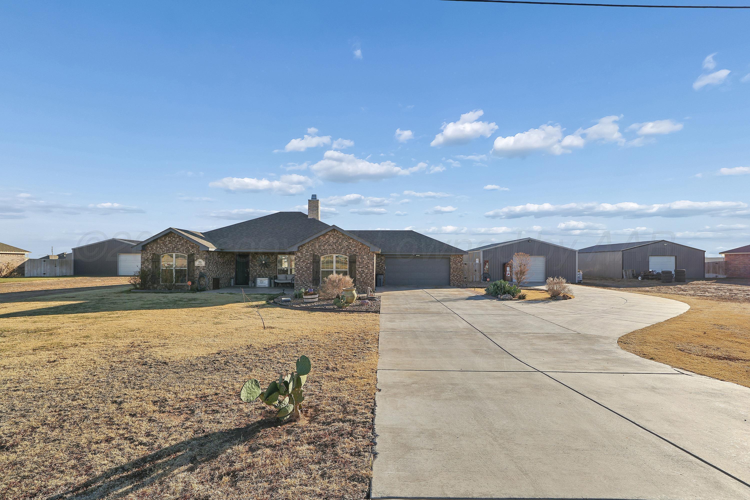 9715 Mossberg Street Canyon, TX 79015 - Photo 2 of 32 a view of a house with a yard and covered with snow in the background