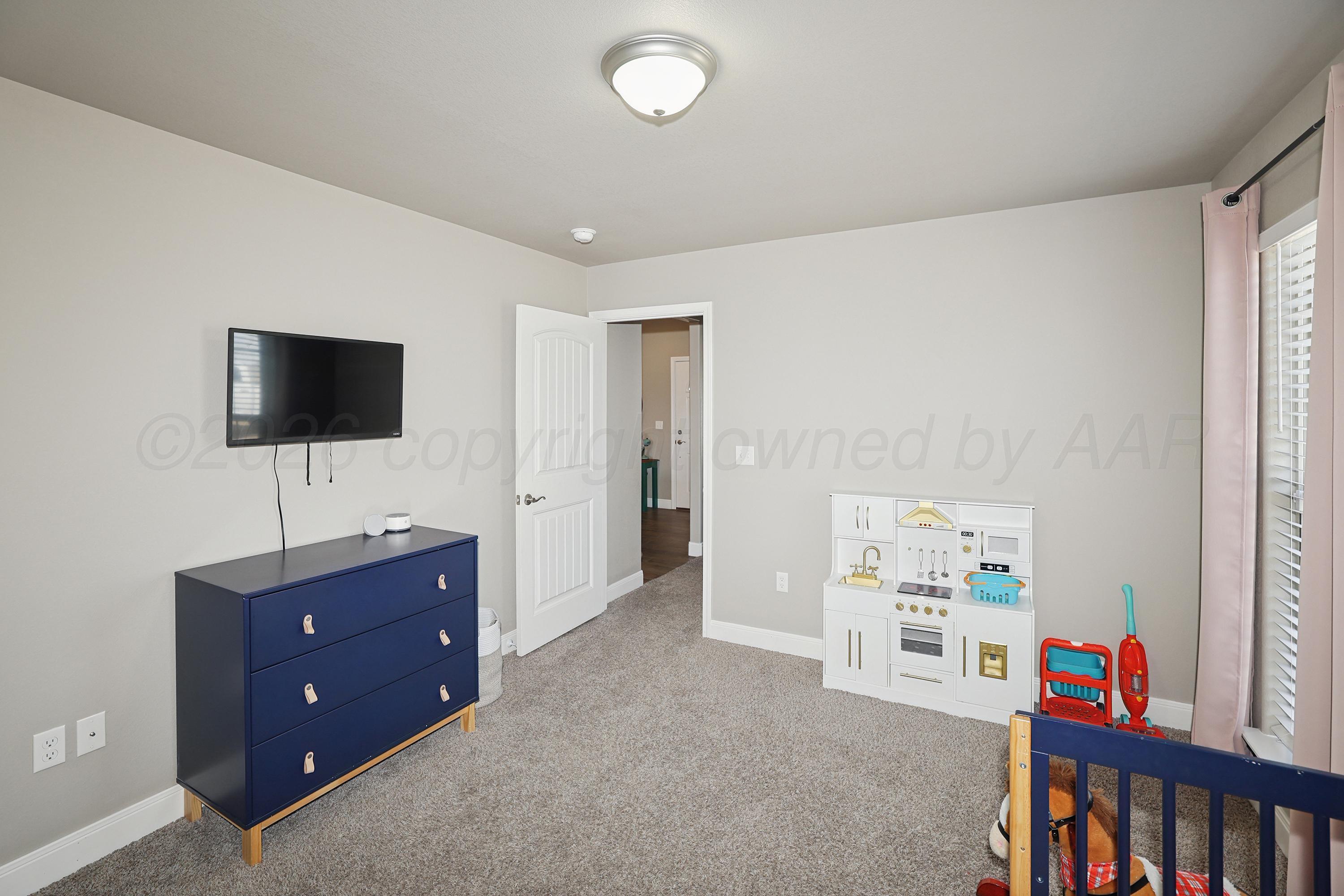 9715 Mossberg Street Canyon, TX 79015 - Photo 21 of 32 a living room with furniture and a flat screen tv
