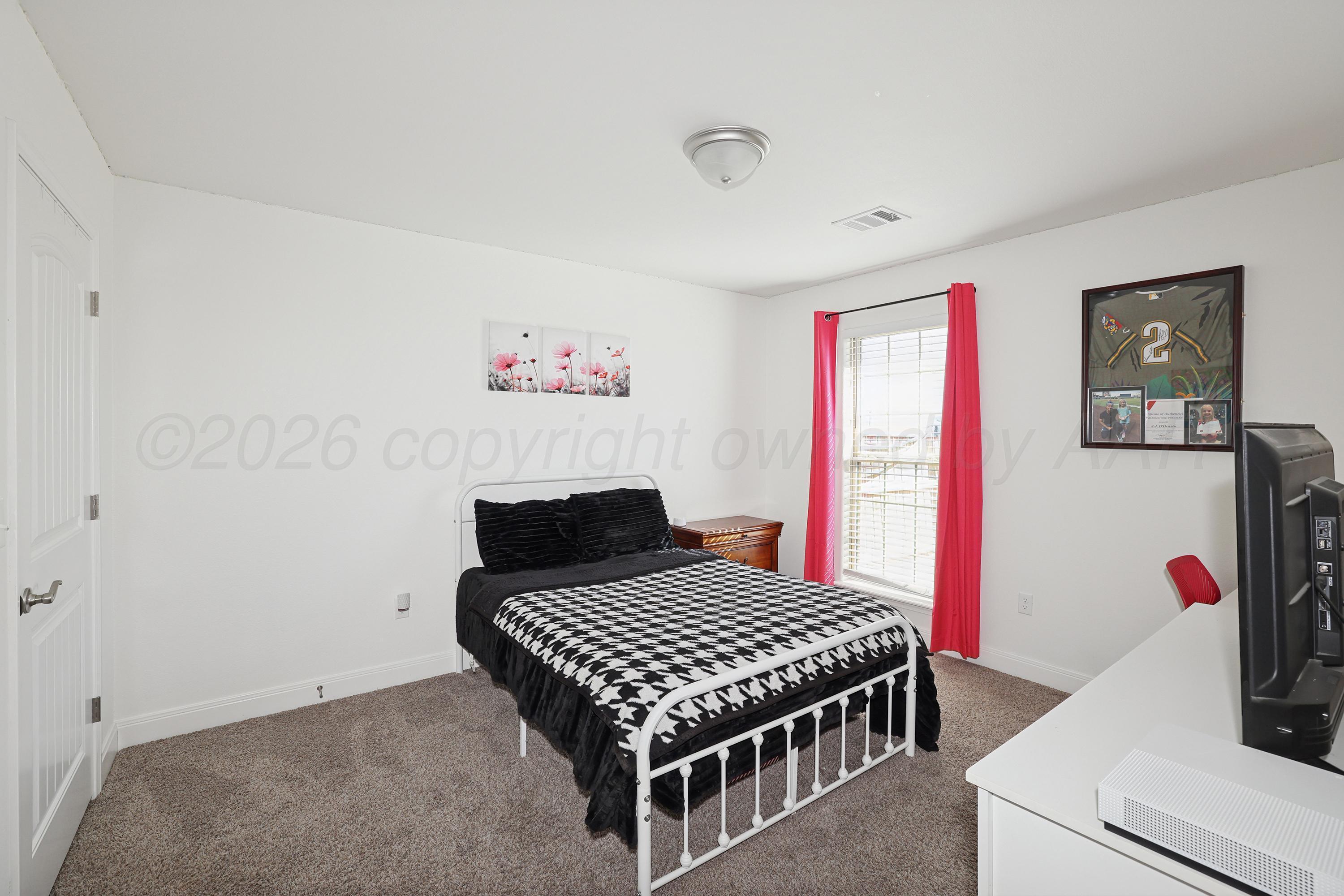 9715 Mossberg Street Canyon, TX 79015 - Photo 23 of 32 a bedroom with a bed and dresser