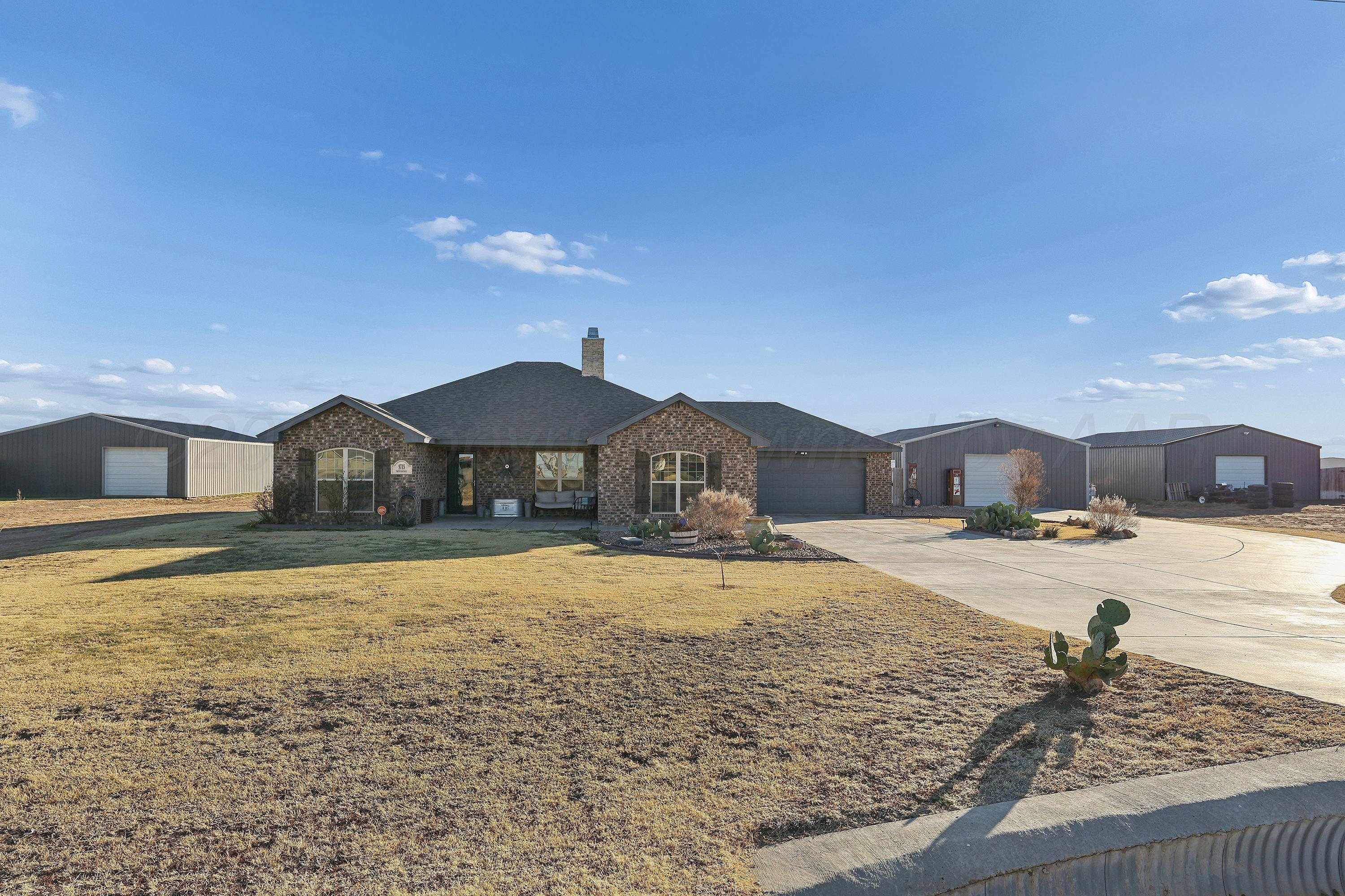 9715 Mossberg Street Canyon, TX 79015 - Photo 3 of 32 a front view of a house with a yard