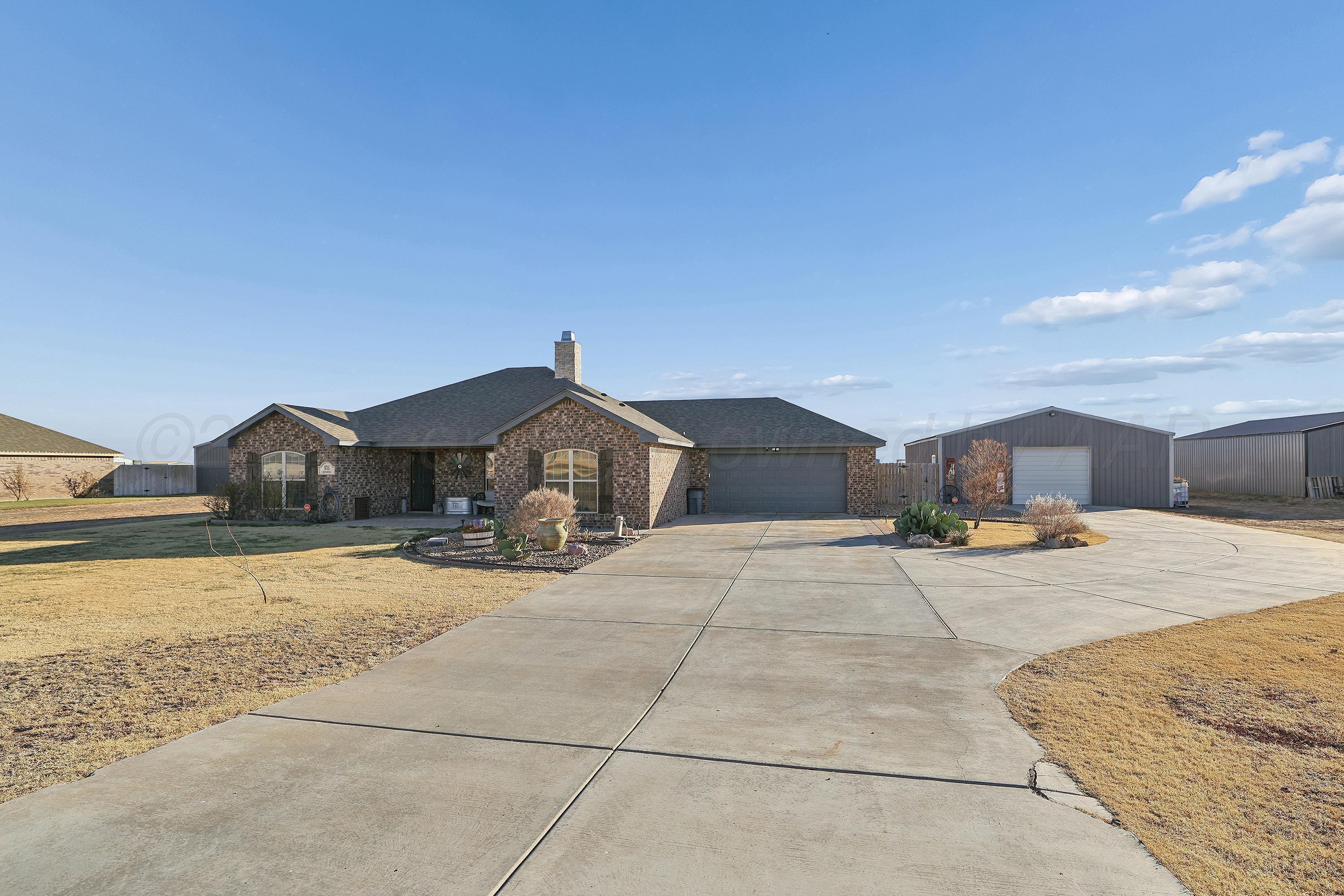 9715 Mossberg Street Canyon, TX 79015 - Photo 4 of 32 a view of a house with a yard and sitting area