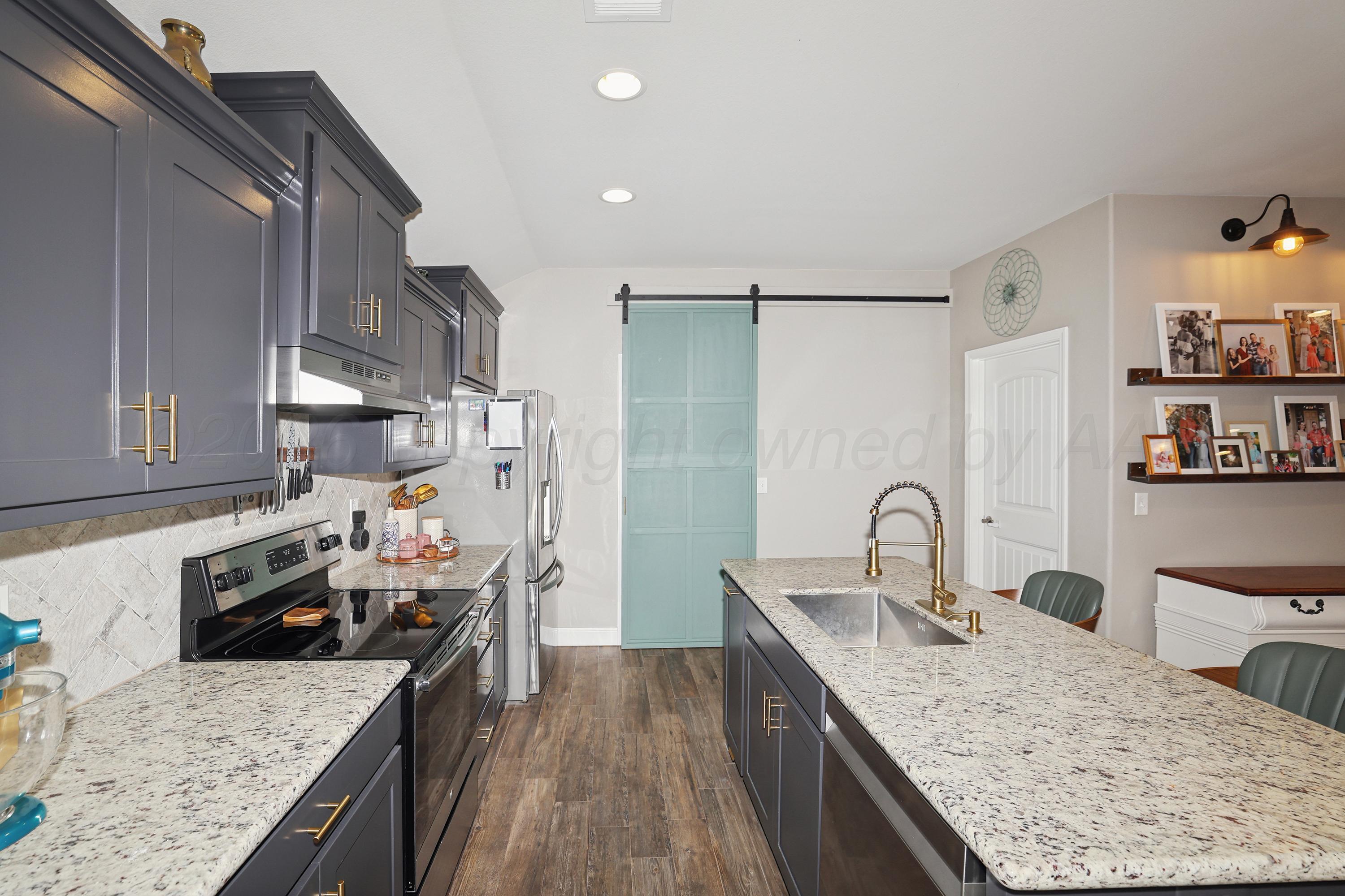 9715 Mossberg Street Canyon, TX 79015 - Photo 9 of 32 a kitchen with stainless steel appliances granite countertop a sink stove and refrigerator
