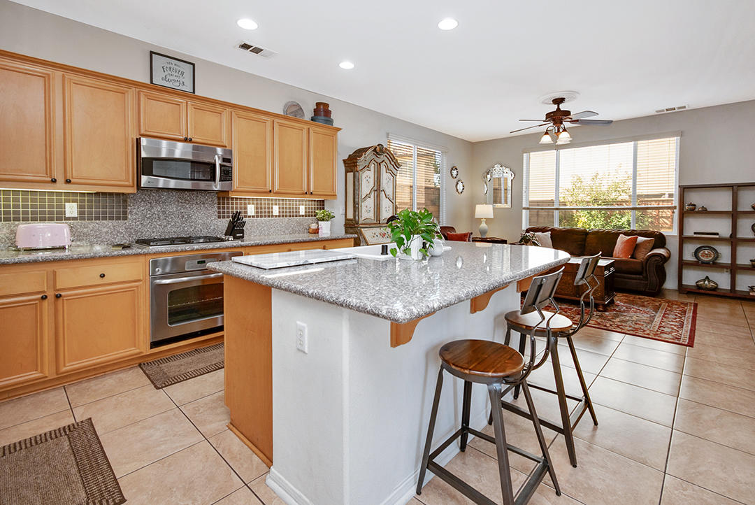 28938 Mirada Circulo Valencia, CA 91354 - Photo 13 of 56 a kitchen with stainless steel appliances granite countertop a stove a sink and a refrigerator